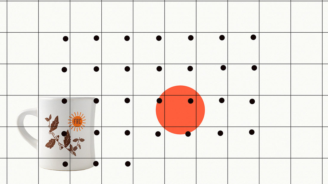 An minimalist calendar with a red dot on a date and a coffee mug in the background.
