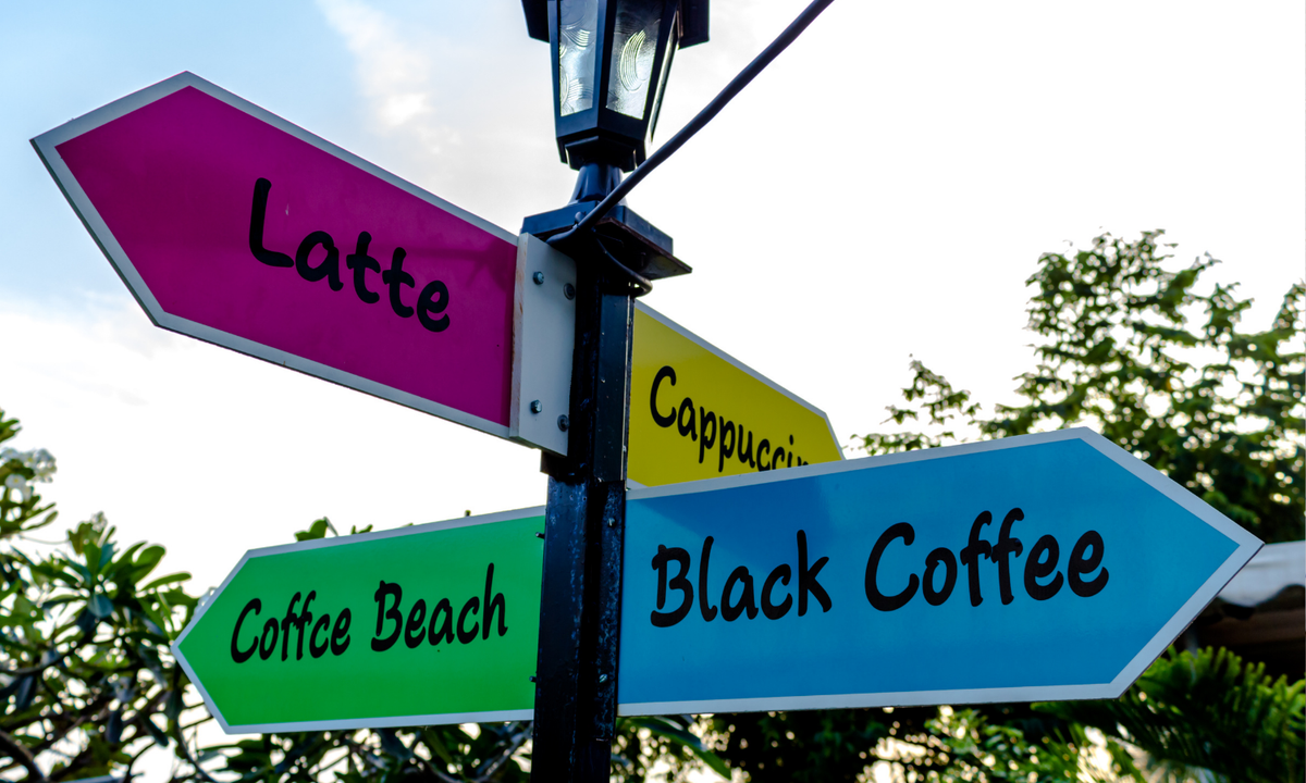 street signs with different coffees listed on them 