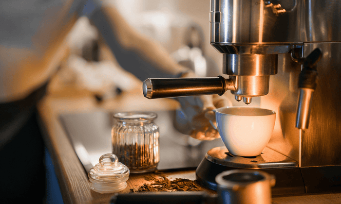 Espresso brew set up with maker, cup, and beans